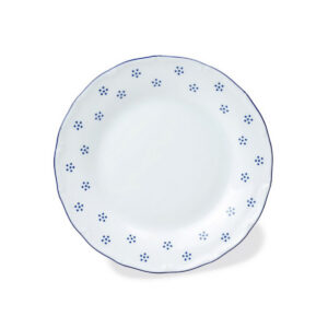 Bílý porcelánový dezertní talíř Valbella s modrým vlnitým okrajem a tečkovaným vzorem.